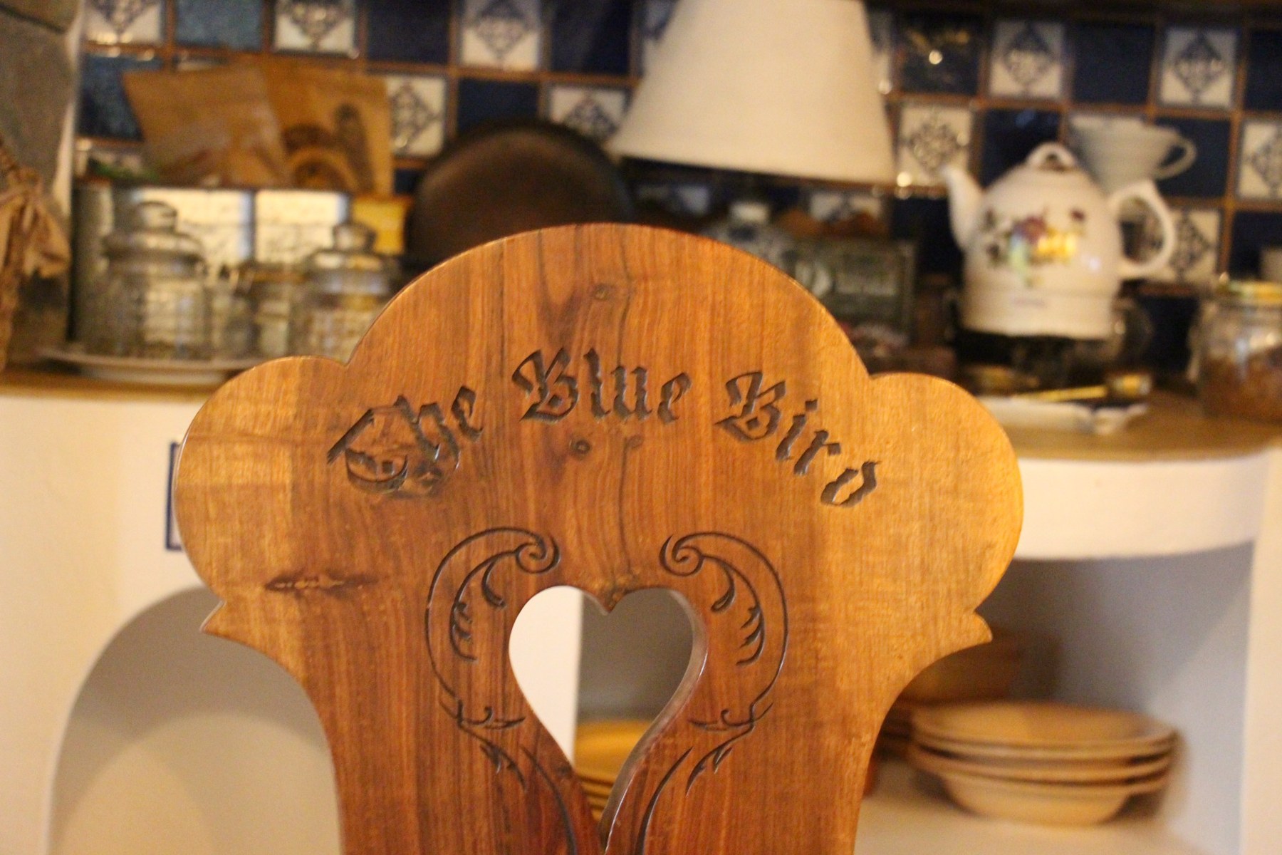 The Blue Bird carved timber detail at Bluebird Homestead